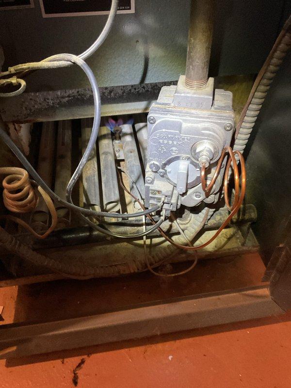 Responded to service call for boiler with pilot light failure. Inspected gas valve assembly and found worn thermocouple causing pilot outage. Replaced thermocouple, cleaned pilot assembly, and verified proper pilot flame. System now functioning correctly with stable pilot light and normal heating operation.