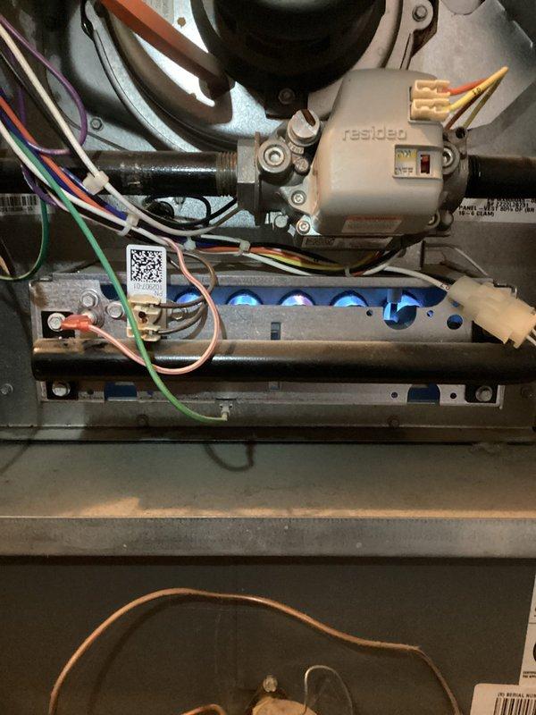 Responded to no-heat call for 3-year-old furnace (MVP 2025). Diagnosed electrical issue affecting ignition sequence. Inspected interior components including Resideo motor and wiring connections. Observed blue flame indication at burners after repair, confirming proper ignition restored. System now heating correctly with all safety functions operational.