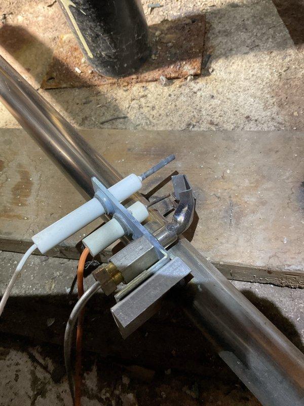 Responded to no heat call for Weil-McLain furnace. Upon inspection, found faulty ignition system with damaged electrodes and pilot assembly. Cleaned corroded connections, replaced ignition electrode, and restored proper flame sensing. System now operating with normal heat output.