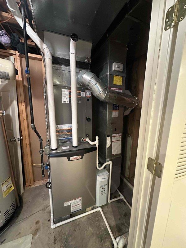 Completed installation of a new Lennox 90% efficient furnace with air conditioning system and hot water tank. Verified proper electrical connections at the disconnect box with 45A/250VAC TR45R fuses. System includes properly installed PVC venting with all required ductwork modifications and connections to ensure optimal performance.