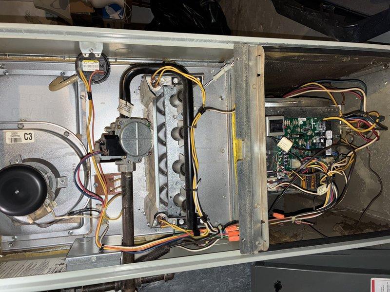 Performed comprehensive furnace tune-up on aging unit. Inspected and cleaned internal components including blower motor assembly and heat exchanger which showed normal dust accumulation. Examined Emerson control board and electrical connections for proper functionality; all wiring and terminals were secure with no signs of damage or corrosion.