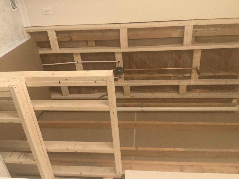 Completed installation of bathroom renovation including framing knee wall between tub and shower, installing 5' x 32" skirt tub, and 4' x 3' shower base. Connected all drain and water lines for both fixtures and prepared mounting areas for customer-supplied Moen Eva deck mount faucet, valve, and shower trim in chrome finish. Customer will complete finish tile work and final knee wall surfacing.