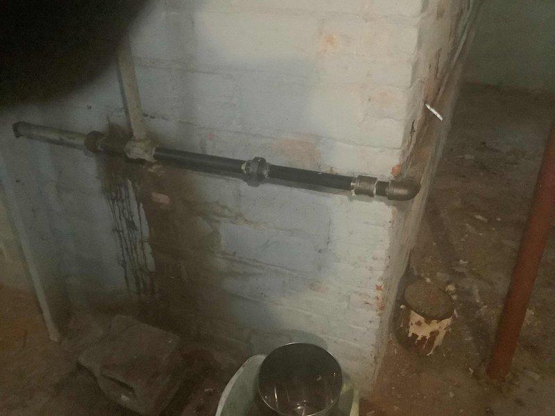 Replaced leaking section of steam boiler condensate return line by cutting out corroded black iron pipe and installing new black iron pipe with union connection. Remediated significant rust buildup at pipe joints that was causing water damage to surrounding wall area.