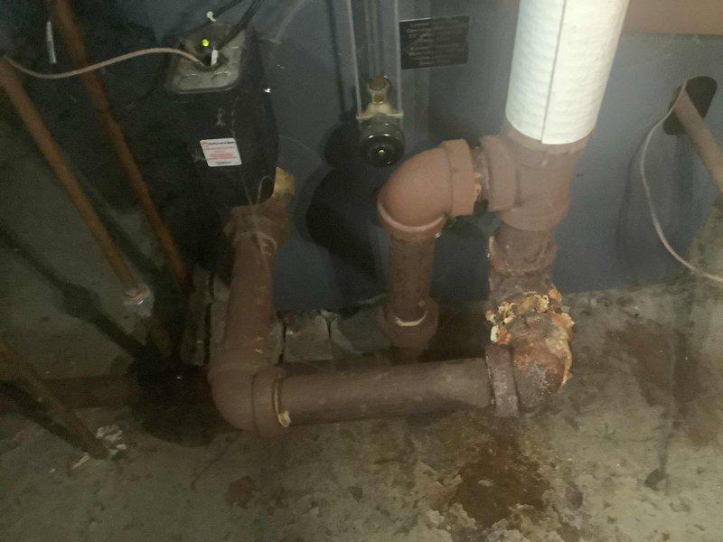 Replaced leaking section of steam boiler condensate return line by cutting out corroded black iron pipe and installing new black iron pipe with union connection. Remediated significant rust buildup at pipe joints that was causing water damage to surrounding wall area.