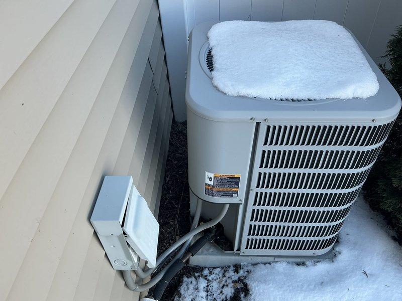 Conducted comprehensive assessment of existing HVAC system, including inspection of outdoor AC unit with significant snow accumulation and evaluation of indoor Carrier air handler unit in mechanical room. Prepared replacement estimate for complete system upgrade, noting current installation's age and configuration with particular attention to ductwork connections and utility interfaces.