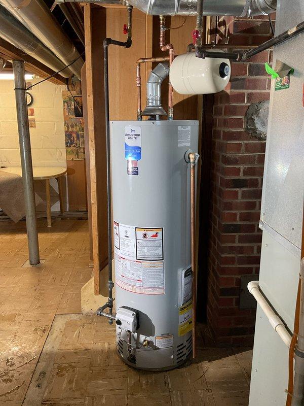 Replaced 40-gallon tall water heater under warranty with pre-staged equipment from shop. Installation included new water heater kit, properly connecting copper supply lines with appropriate shutoff valves, and ensuring proper venting through existing PVC and metal flue system. Richmond unit was successfully installed with expansion tank in utility area against brick wall.