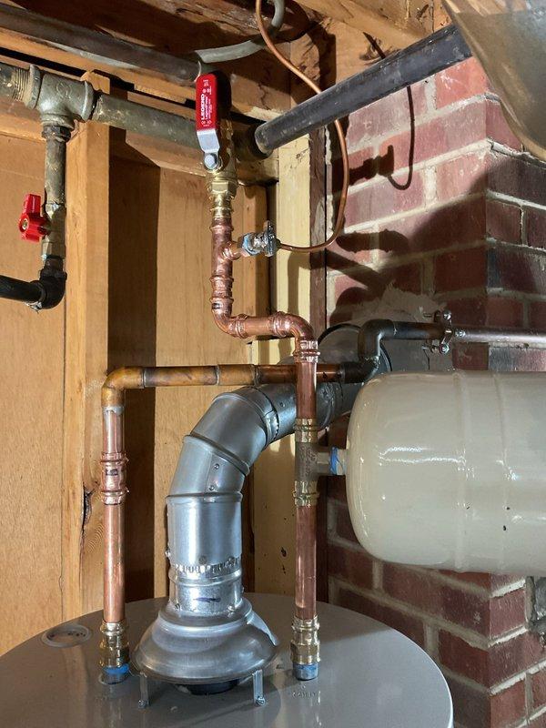 Replaced 40-gallon tall water heater under warranty with pre-staged equipment from shop. Installation included new water heater kit, properly connecting copper supply lines with appropriate shutoff valves, and ensuring proper venting through existing PVC and metal flue system. Richmond unit was successfully installed with expansion tank in utility area against brick wall.