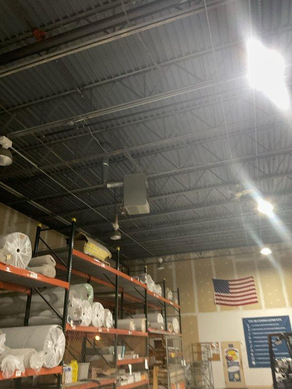 Responded to commercial no-heat call for a Reznor heater mounted 25 feet high in warehouse area. Accessed unit via customer's caged forklift. Discovered frost buildup on heat exchanger coil indicating possible refrigerant flow restriction. Performed maintenance service and restored proper operation. Discussed ongoing maintenance plan options with customer for all HVAC equipment on site.