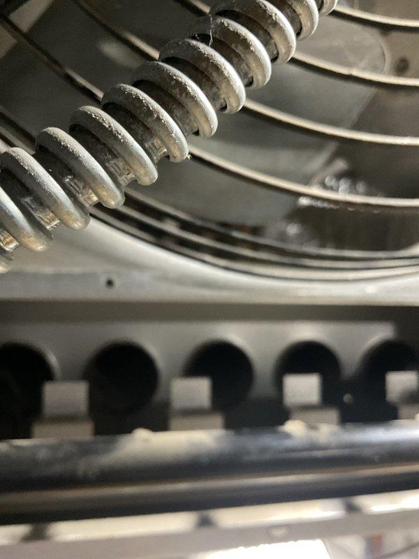 Responded to commercial no-heat call for a Reznor heater mounted 25 feet high in warehouse area. Accessed unit via customer's caged forklift. Discovered frost buildup on heat exchanger coil indicating possible refrigerant flow restriction. Performed maintenance service and restored proper operation. Discussed ongoing maintenance plan options with customer for all HVAC equipment on site.