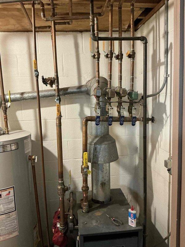 Conducted inspection of Weil-McLain boiler system in basement utility room. System appears aged but operational with proper expansion tank and valve configuration. Client has maintained heat functionality for 20+ years. Provided estimate for potential replacement or servicing as requested.