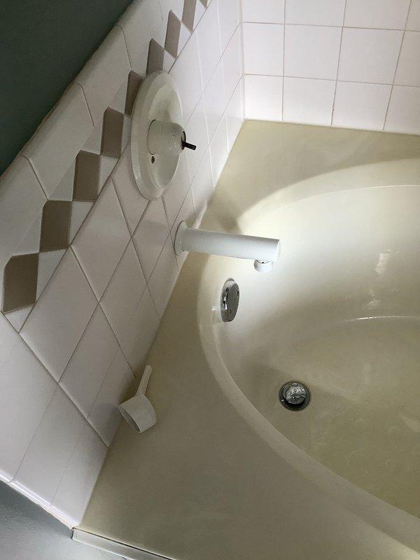 Repaired leaking garage spigot by accessing and replacing damaged supply line valves behind wall access panel. Completed bathtub faucet replacement in upstairs bathroom, ensuring proper installation and function with no leaks after testing.
