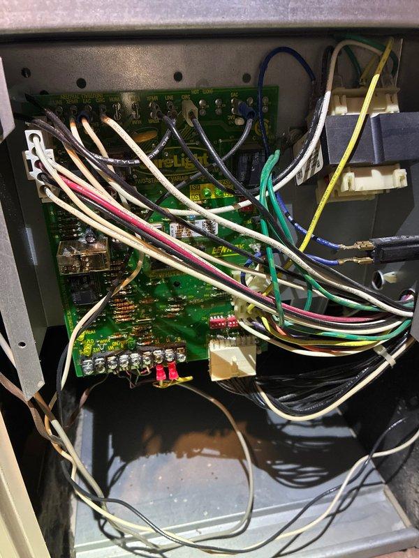 Performed routine maintenance on 20-year-old Lennox furnace. Inspected electrical control panel including SureLight circuit board and wiring connections. Noted some moisture in the control enclosure that may require future attention.