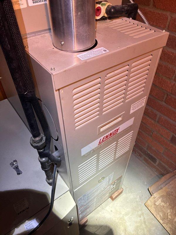 Performed routine maintenance on 20-year-old Lennox furnace. Inspected electrical control panel including SureLight circuit board and wiring connections. Noted some moisture in the control enclosure that may require future attention.