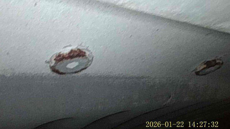 Completed routine tune-up service on two HVAC systems (21 years and 2 years old). During inspection, identified water damage on ceiling, evidenced by circular brown stains, likely indicating condensate drain issues or possible refrigerant leak. Documented corrosion on nearby surfaces for future reference.