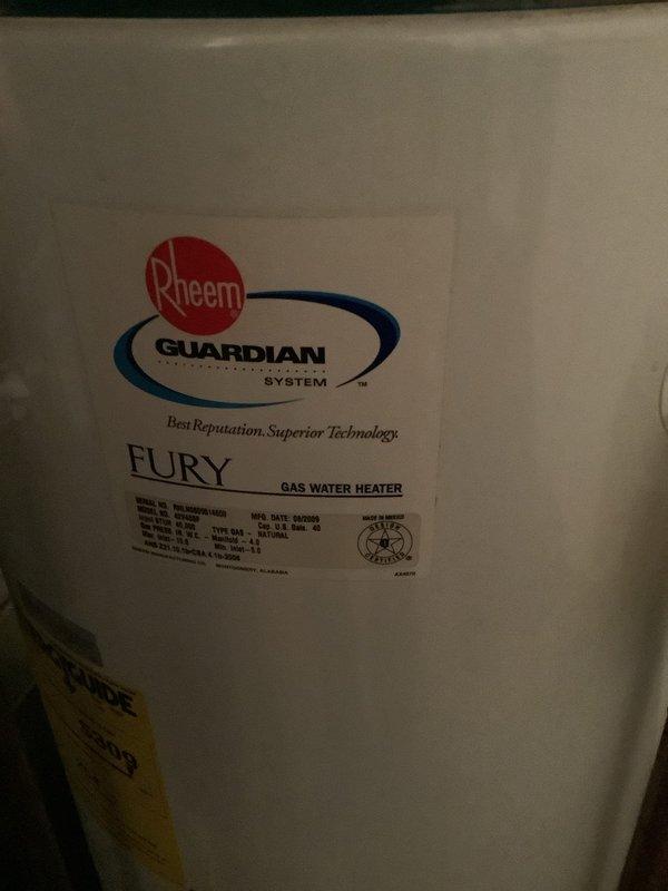 Responded to customer's call regarding leaking hot water tank. Upon inspection, found Guardian Fury gas water heater showing signs of corrosion and mineral deposits around pipe connections. Replaced aging unit with new Rheem Fury gas water heater, ensuring proper installation of all copper pipes and connections with appropriate valving.