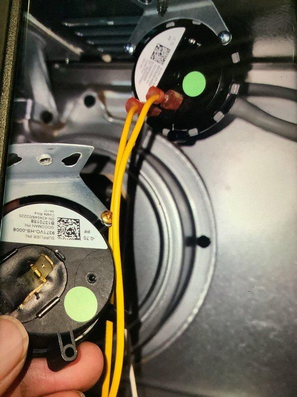 Diagnosed and repaired a 10+ year old furnace that was blowing cold air during urgent no-heat call. Testing revealed faulty pressure switches preventing proper ignition sequence. Replaced both pressure switches (identified by green circular stickers) and verified proper operation with multimeter testing, restoring heat function to the system.