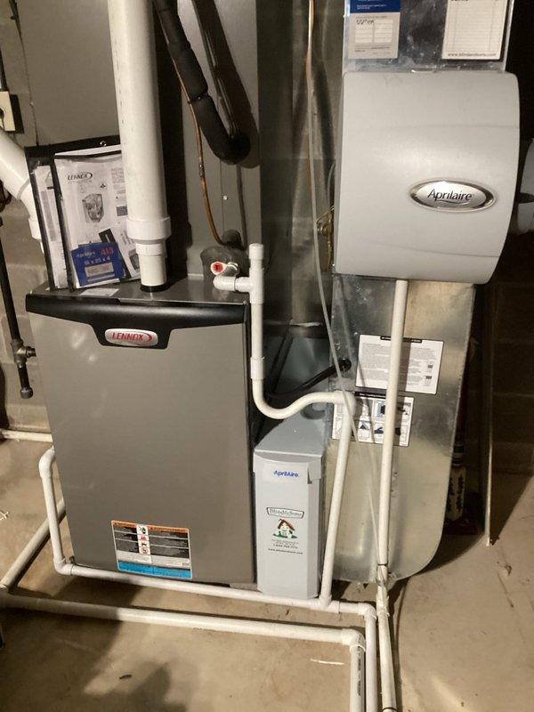 Performed scheduled MVP Heating maintenance service on 2-year-old Lennox furnace system with attached Aprilaire humidifier and air purifier. Inspected complete system setup including ventilation, drainage components, and electrical connections. Removed, inspected, and cleaned the air filter which showed normal accumulation of airborne particles, then reinstalled and confirmed proper system operation.