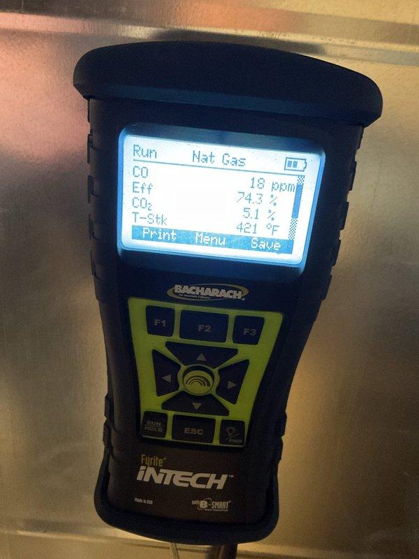 Performed scheduled MVP Heating maintenance service and identified groundhog damage to installation hole requiring tape repair. Conducted combustion analysis using Bacharach Fyrite INTECH analyzer, which showed proper operation with stack temperature at 421°F, CO2 at 74.3%, O2 at 5.1%, and CO efficiency at 18 ppm.