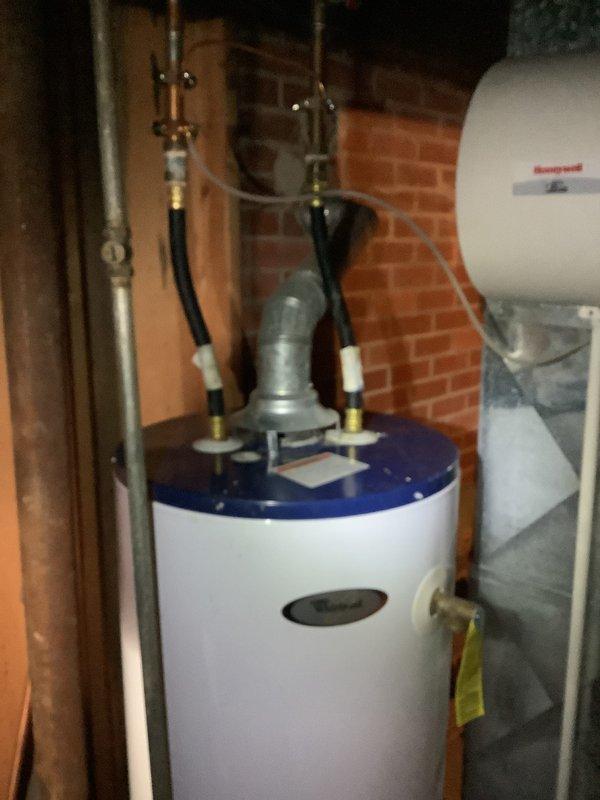 Conducted an estimate for replacement of an 18-year-old furnace system. Inspected the current installation which includes a water heater with connected ventilation and a Honeywell air handler unit mounted in the utility area. Documented the existing equipment condition and configuration to prepare appropriate replacement options.