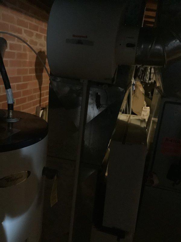 Conducted an estimate for replacement of an 18-year-old furnace system. Inspected the current installation which includes a water heater with connected ventilation and a Honeywell air handler unit mounted in the utility area. Documented the existing equipment condition and configuration to prepare appropriate replacement options.