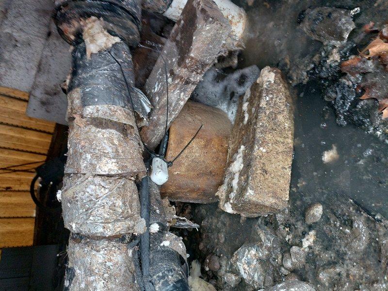 Responded to customer dissatisfaction regarding previous heat tape installation. Upon inspection, found severely deteriorated plumbing pipes with extensive corrosion and mineral deposits, along with broken clay/cement pipe containing stagnant water. Properly reinstalled heat tape with adequate length extending into ground per industry standards to ensure correct functionality.