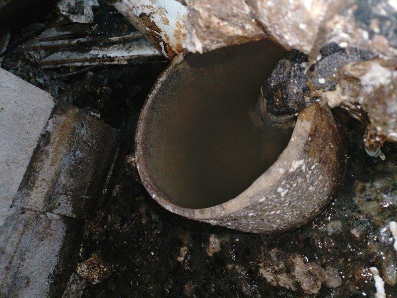 Responded to customer dissatisfaction regarding previous heat tape installation. Upon inspection, found severely deteriorated plumbing pipes with extensive corrosion and mineral deposits, along with broken clay/cement pipe containing stagnant water. Properly reinstalled heat tape with adequate length extending into ground per industry standards to ensure correct functionality.