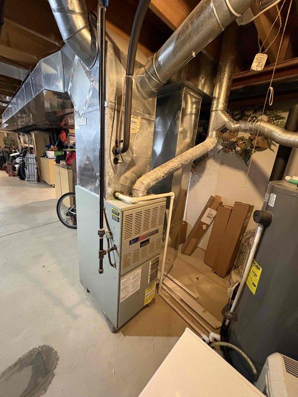 Conducted full evaluation of 26-year-old furnace system in residential basement requiring replacement. Inspected existing ductwork configuration, electrical panel capacity (noting six 20-amp circuit breakers), and current installation setup. Provided comprehensive replacement estimate for new furnace system with appropriate specifications to replace aging equipment.