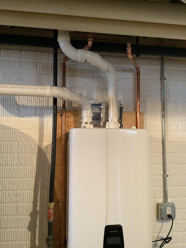 Successfully completed replacement of a 50-gallon power vent water heater with a new Navien tankless water heater. Installation included proper mounting of the unit to the utility room wall, connection of copper supply/return lines, and installation of PVC venting system. All connections were properly sealed and tested to ensure optimal performance and no leaks.