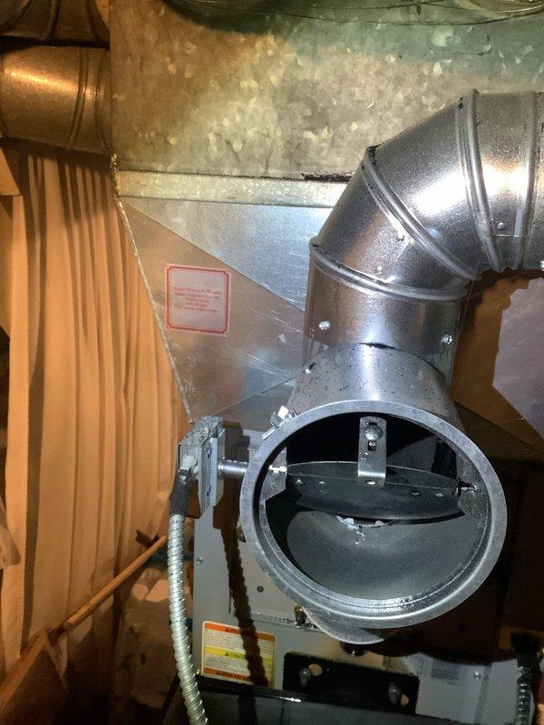 Responded to no-heat complaint on oil furnace previously serviced by technicians Jibreel and Chris. Inspected furnace system and ductwork connections, noting significant wear on surrounding surfaces. Verified proper installation of metal ductwork components including elbow joints and connection points to air handler. System is now operational and providing heat.