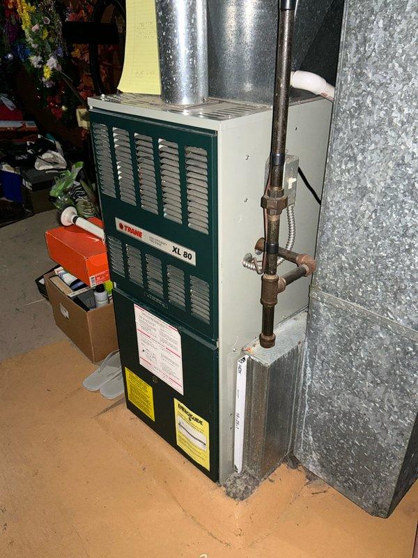 Responded to no heat service call and inspected existing Trane XL 80 high efficiency two-stage furnace. System appears to be installed in basement utility area with proper ductwork connections. Observed oxidation on copper piping at joints. Provided replacement estimate for furnace unit.