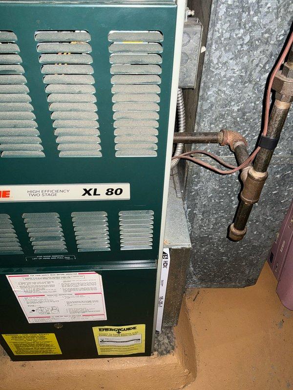 Responded to no heat service call and inspected existing Trane XL 80 high efficiency two-stage furnace. System appears to be installed in basement utility area with proper ductwork connections. Observed oxidation on copper piping at joints. Provided replacement estimate for furnace unit.