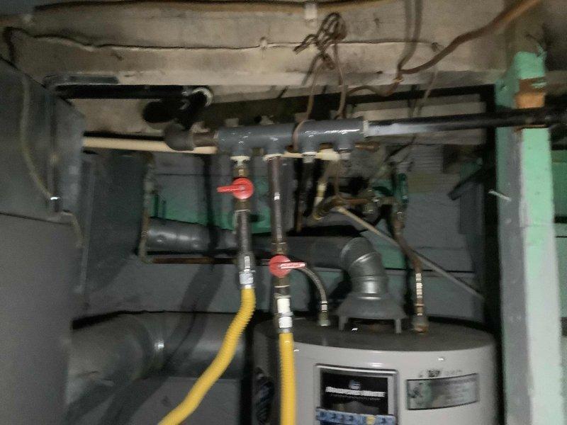 Responded to customer report of gas leak in 123-year-old residential property. Performed comprehensive pressure testing of gas lines in utility area. Inspected water heater installation and associated gas connections, identifying and repairing leak at brass fitting junction. Verified system integrity with follow-up pressure test confirming successful remediation.