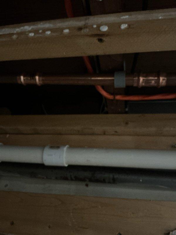 Conducted follow-up inspection after restoration company exposed plumbing in ceiling area as previously requested. Assessed water supply issue by examining exposed copper supply lines and PVC drainage pipes between structural joists. Documented current condition with photos for repair planning through customer's MVP repair discount program.