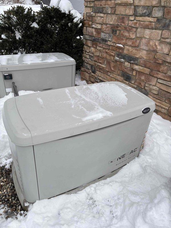 Responded to service call for generator showing red light. Upon inspection, verified generator disconnect was properly engaged and GFI breaker was functioning correctly. Green indicator light confirmed system is now operational. Cleared snow accumulation from around outdoor units to ensure proper ventilation and access.