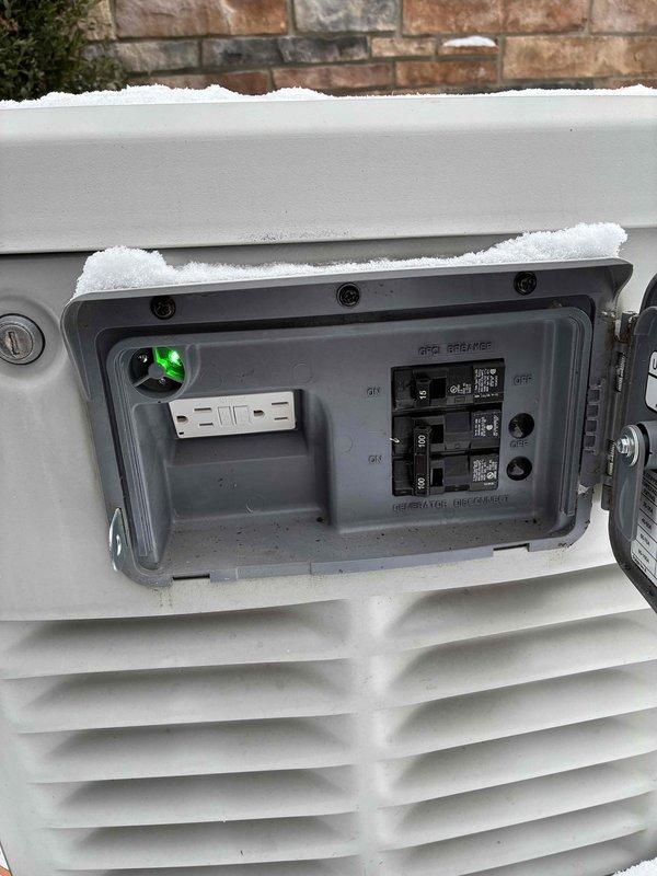 Responded to service call for generator showing red light. Upon inspection, verified generator disconnect was properly engaged and GFI breaker was functioning correctly. Green indicator light confirmed system is now operational. Cleared snow accumulation from around outdoor units to ensure proper ventilation and access.