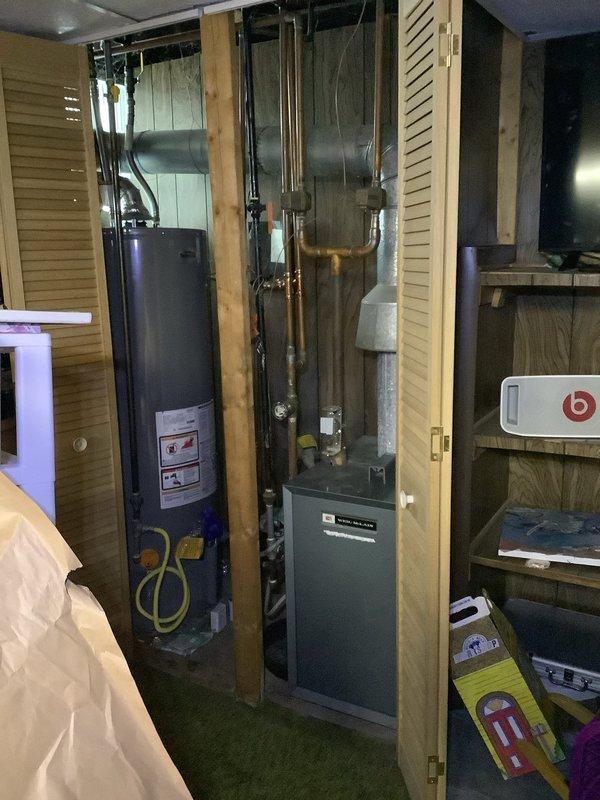 Responded to service call for an aging boiler with heating performance issues. Upon inspection, found the expansion tank and associated copper piping showing signs of normal oxidation. Confirmed proper operation of control units/sensors mounted on the system and verified heating function, though the unit's advanced age contributes to its diminished efficiency.