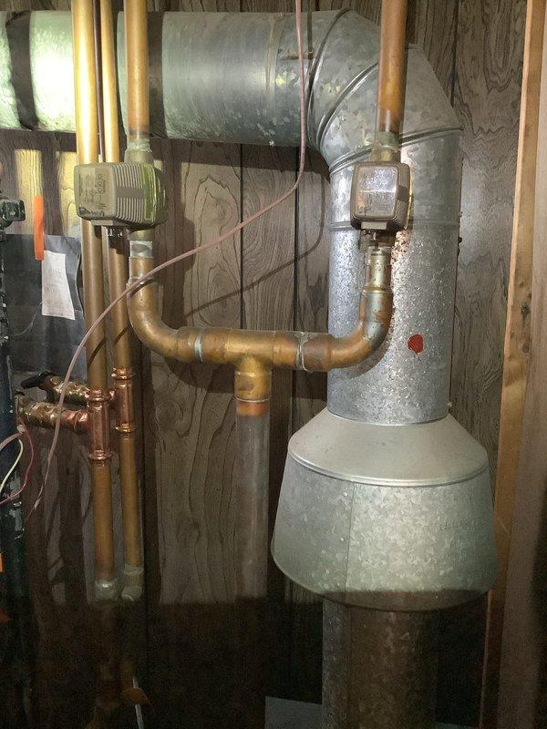 Responded to service call for an aging boiler with heating performance issues. Upon inspection, found the expansion tank and associated copper piping showing signs of normal oxidation. Confirmed proper operation of control units/sensors mounted on the system and verified heating function, though the unit's advanced age contributes to its diminished efficiency.