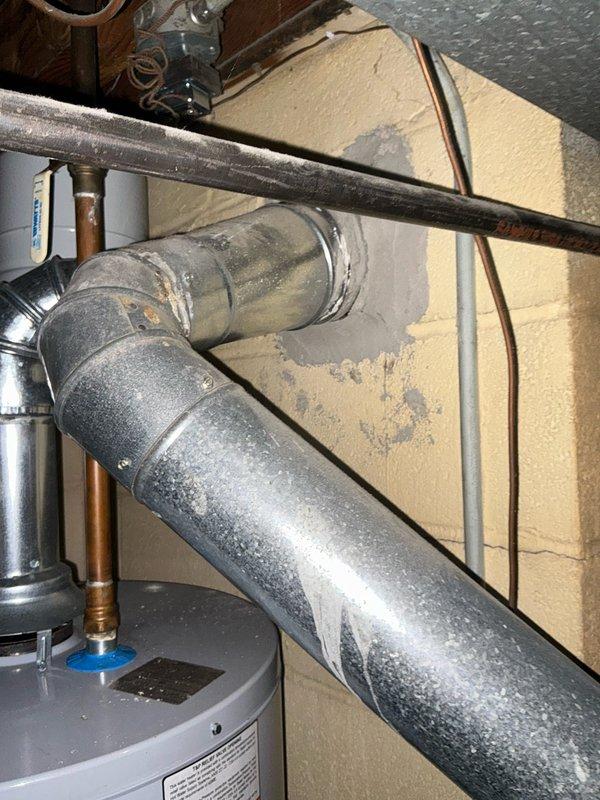 Conducted inspection of Trane XL 80 furnace system in basement utility room for replacement estimate. Evaluated existing installation including metal ductwork connections, PVC condensate drainage, and exhaust venting. Noted wall penetration for exhaust duct requires repair work during replacement. Documented current system configuration to prepare comprehensive replacement proposal.