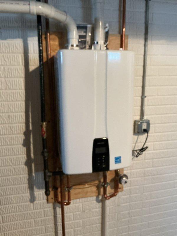 Responded to no hot water issue in bathroom. Inspected recently installed PCB tankless water heater system. Confirmed RH drive was clear and operational. Verified proper connection of copper supply lines and PVC venting. System now functioning correctly with adequate hot water delivery to bathroom fixtures.