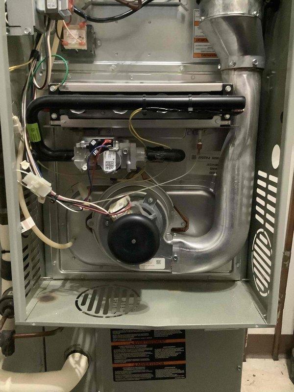 Performed comprehensive cooling system maintenance service as part of customer's maintenance plan. Inspected furnace blower motor assembly and electrical components, finding all connections secure and operational. Examined evaporator coil, noting accumulated dust and debris on mesh screen which was cleaned to improve system efficiency and airflow.