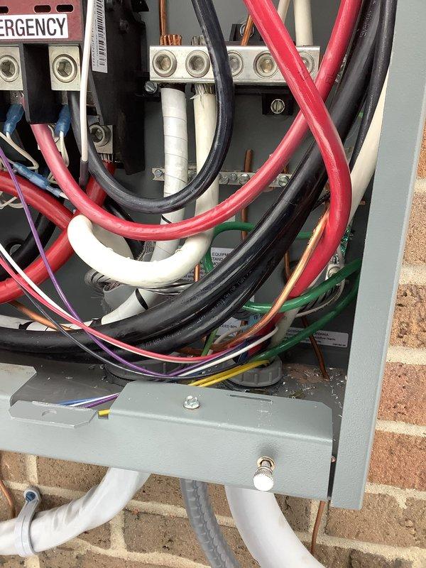 Completed inspection of emergency electrical panel and transfer switch system. Replaced incorrect identification sticker on transfer switch with proper sticker from warehouse inventory. Verified circuit breaker panel connections and wiring in preparation for scheduled inspection.