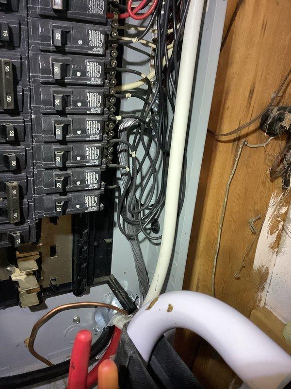 Completed inspection of emergency electrical panel and transfer switch system. Replaced incorrect identification sticker on transfer switch with proper sticker from warehouse inventory. Verified circuit breaker panel connections and wiring in preparation for scheduled inspection.