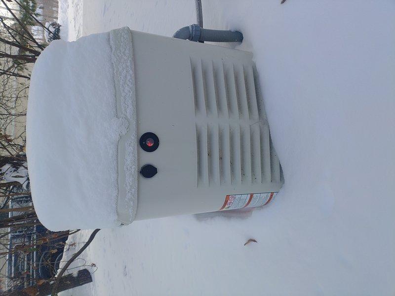 Responded to service call for a Generac Evolution 2.0 generator that failed to start with red indicator light illuminated. Inspected unit which was covered in significant snow accumulation. Cleared snow from generator housing and ventilation slots, tested control panel functionality, and reset system. Generator now operating normally with no fault codes present.