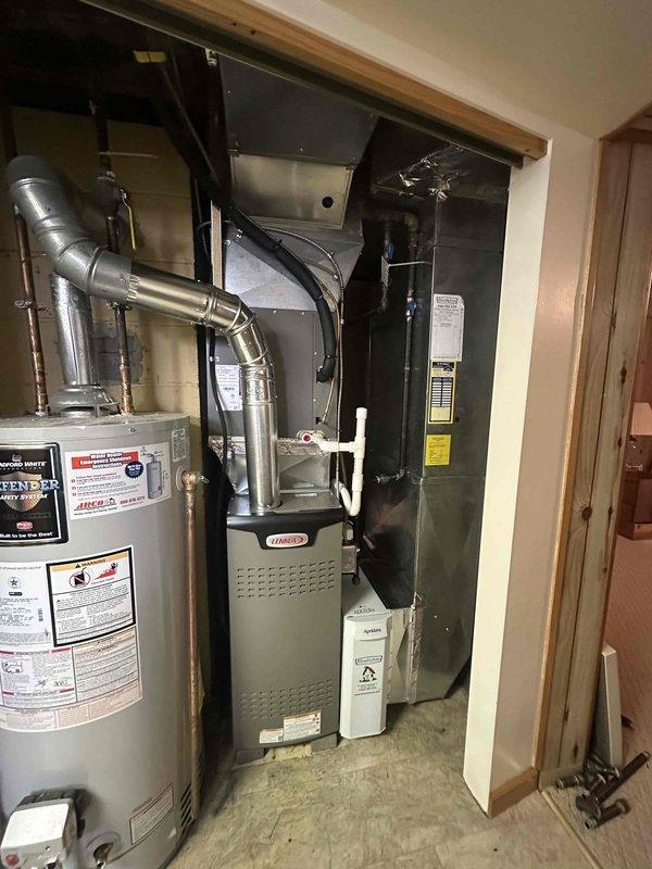 Completed installation of 80% efficiency Lennox furnace as scheduled follow-up service. System properly connected to existing ductwork in utility area adjacent to water heater. Installed and verified functioning Kidde carbon monoxide detector as required by safety regulations.