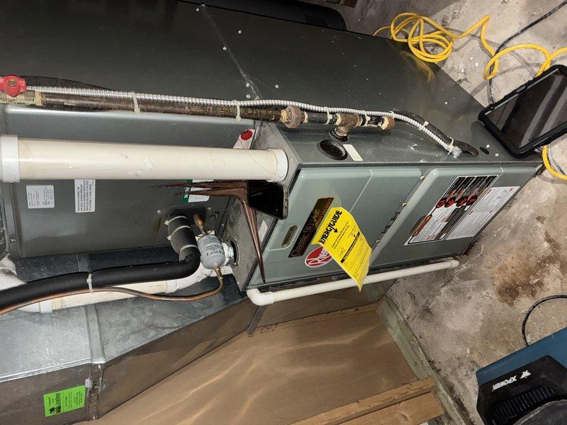 Responded to service call for water leakage into furnace. Performed comprehensive inspection of residential heating system including examination of the furnace unit, connected ductwork, exhaust components, and electrical capacitor. System was verified operational with no current water damage affecting functionality.