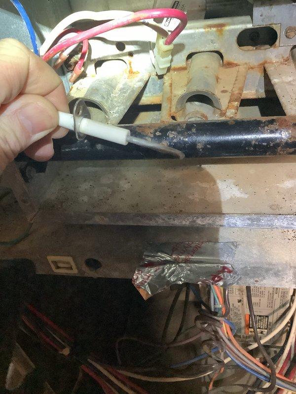 Diagnosed no-heat issue on Amana furnace with operational blower but failing ignition sequence. Inspection revealed significant corrosion on control board mounting plate and deteriorated wire connections. Repaired corroded electrical terminals and restored proper ignition circuit functionality, returning heating system to normal operation.