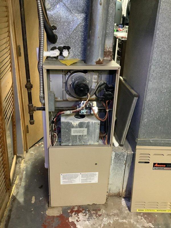 Diagnosed no-heat issue on Amana furnace with operational blower but failing ignition sequence. Inspection revealed significant corrosion on control board mounting plate and deteriorated wire connections. Repaired corroded electrical terminals and restored proper ignition circuit functionality, returning heating system to normal operation.