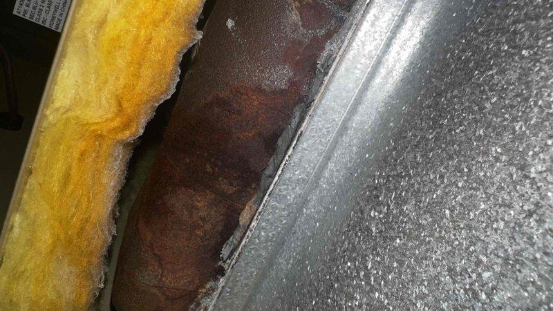 Responded to no heat complaint on 12-year-old boiler system affecting main floor. Inspection revealed extensive corrosion and moisture accumulation on boiler components. Identified rusted metal surfaces with condensation buildup, indicating potential leak or humidity issues compromising system function. Restored heating operation after addressing moisture-related failure points.