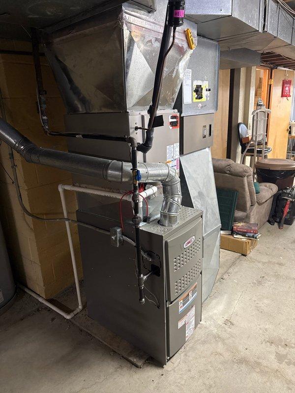 Successfully installed a new 80% efficient furnace in residential basement setting. Completed all necessary ductwork connections and installed proper gas line with shutoff valve. System is operational with all components properly secured and connected.