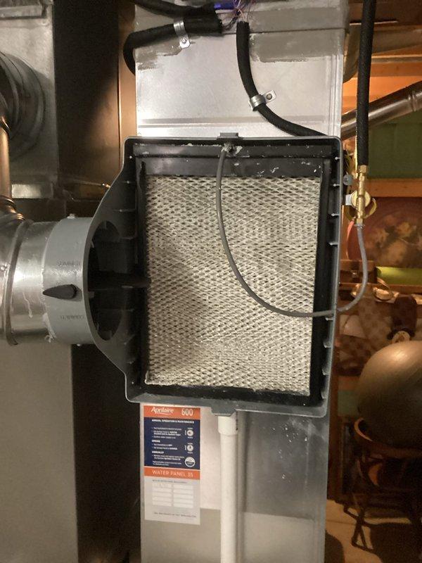 Performed routine tune-up service on a 2-year-old furnace system. Inspected air filter housing and confirmed filter is clean and properly installed. Examined furnace unit with PVC venting system, verified all connections are secure, and confirmed system operation is within normal parameters.